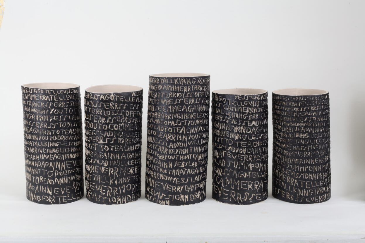 Ceramics created by Barry Finan - lamp post inspired pots which he has covered in writing etched into the surface
