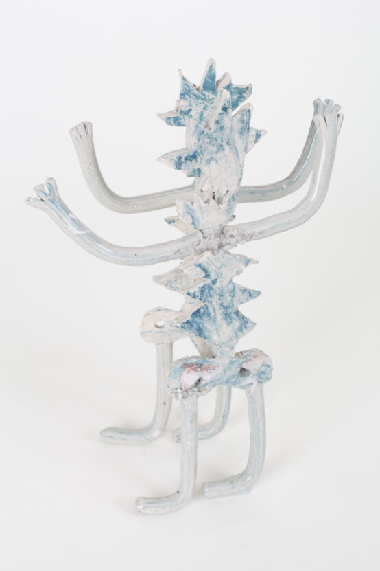 Ceramic sculpture in blue and white with arms and legs