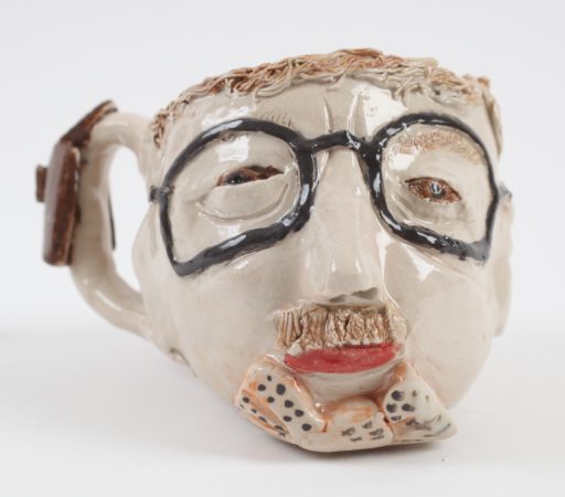 Ceramic mug with a face and glasses, by Horace Lindezey