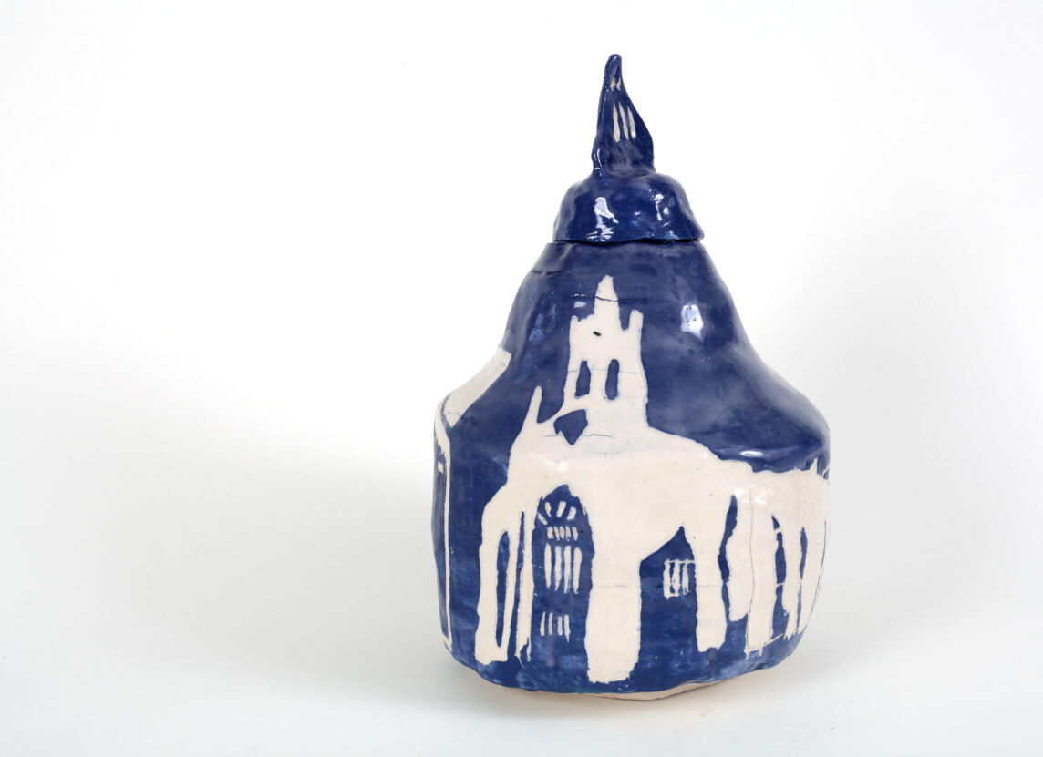 Blue ceramic pot with a white illustration of All Saints Church Plymouth, by Horace Lindezey