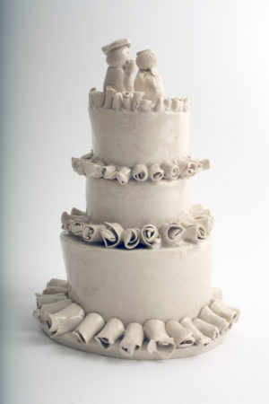 Porcelain wedding cake with three tiers and figurines on top, by Horace Lindezey