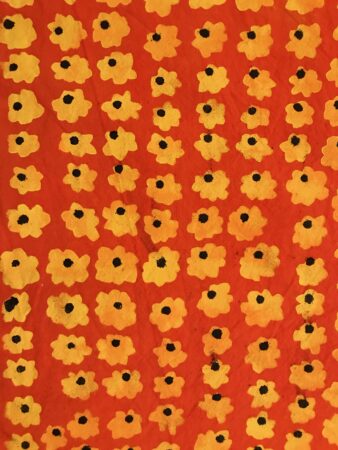 Orange fabric printed with a repeating sunflower design, by Joe Mills