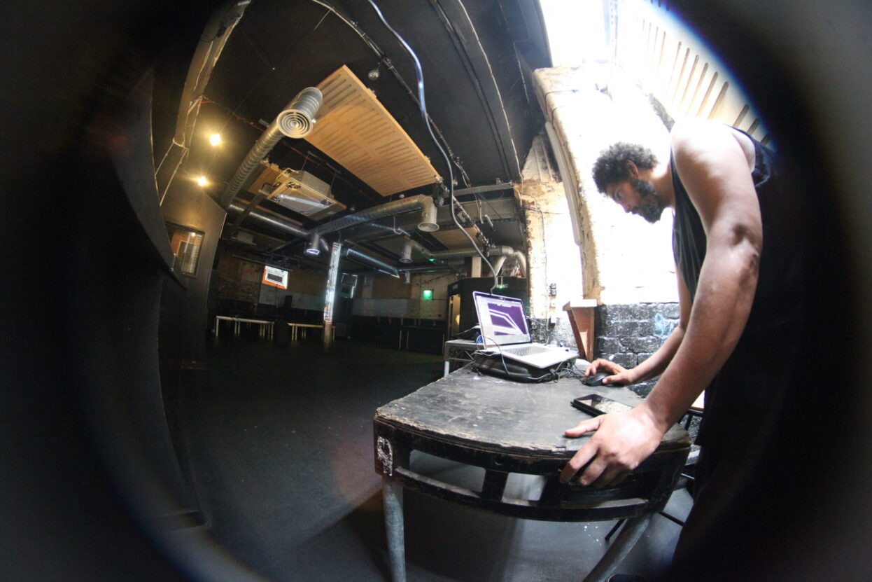 Malik Jama performing projection mapping at SOUP event - photo taken with a fisheye lens