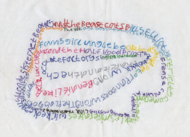 Textile art on white fabric. Multicoloured stitching used to write words with thread.