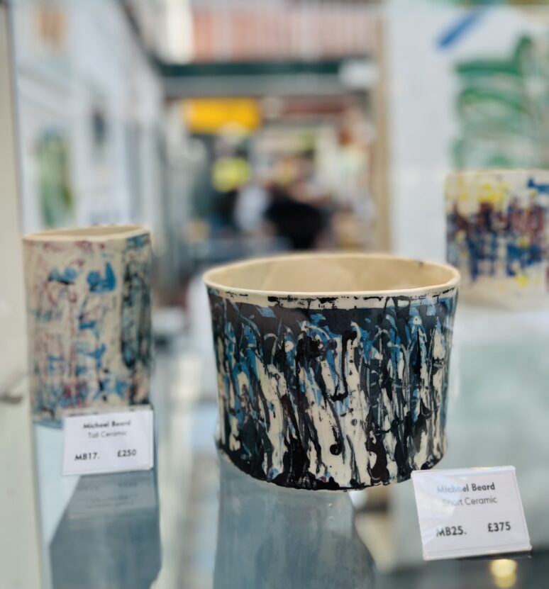 A ceramic pot in a glass case.