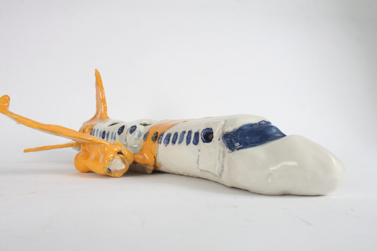 A ceramic model of a white and yellow plane.