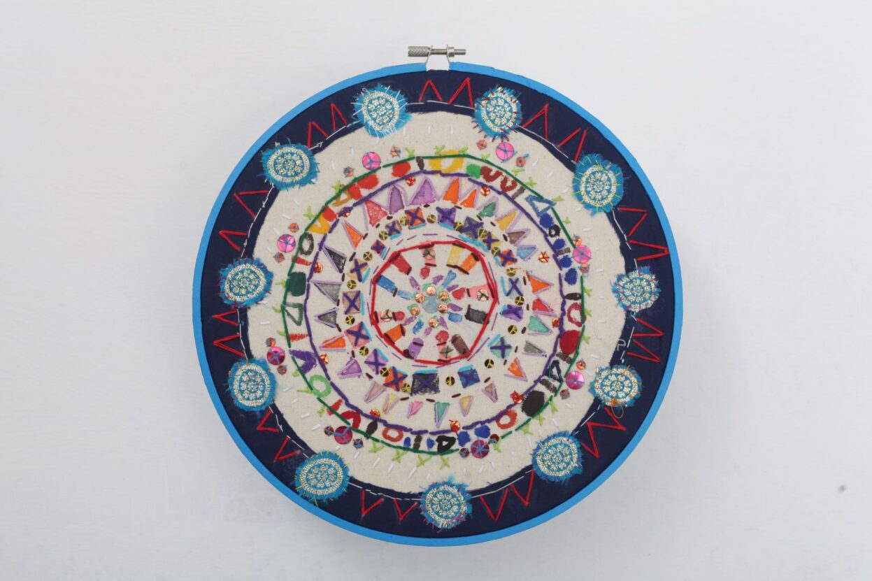 Embroidered mandala, in lots of different colours.