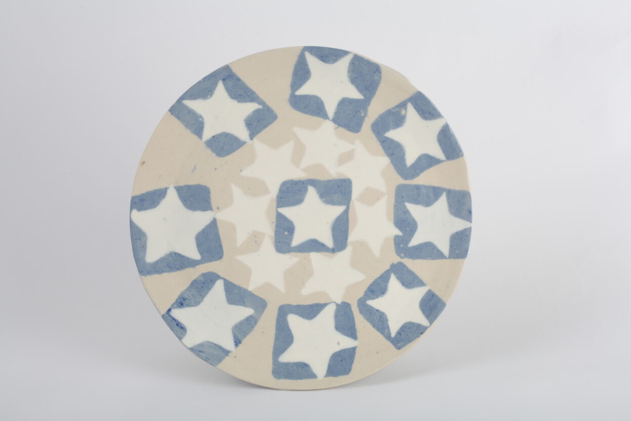 Ceramic plate with blue and white stars on it.