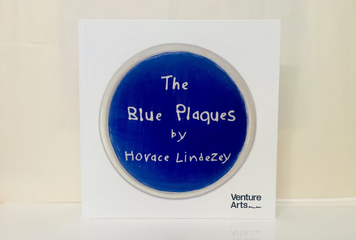 The front cover of a hard back book with a blue plaque on the front which reads 'The Blue Plaques' by Horace Lindezey.