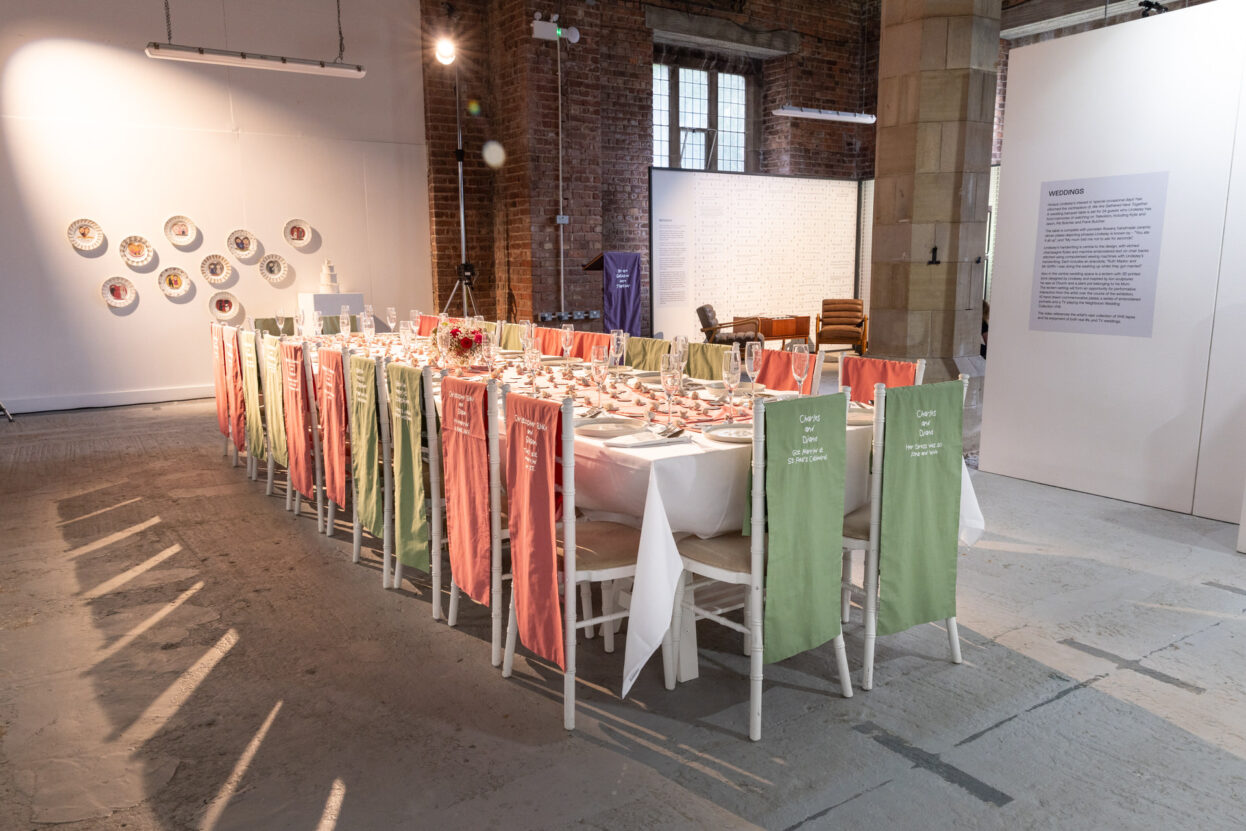 A long table set for a wedding reception with glass and ceramics made by Horace Lindezey