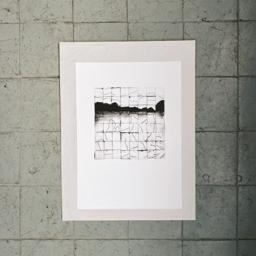 An abstract black and white tiled picture in a grey frame hung on a wall.