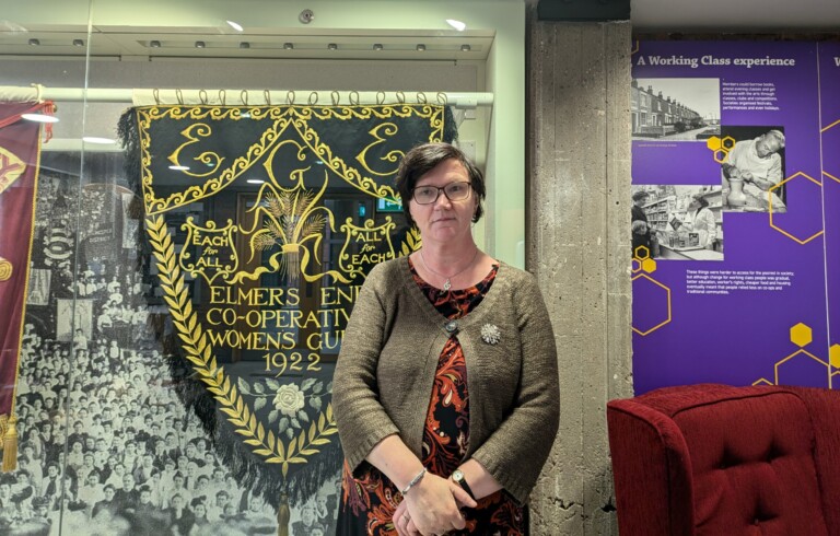 Louise Hewitt stood in front of a museum cabinet.