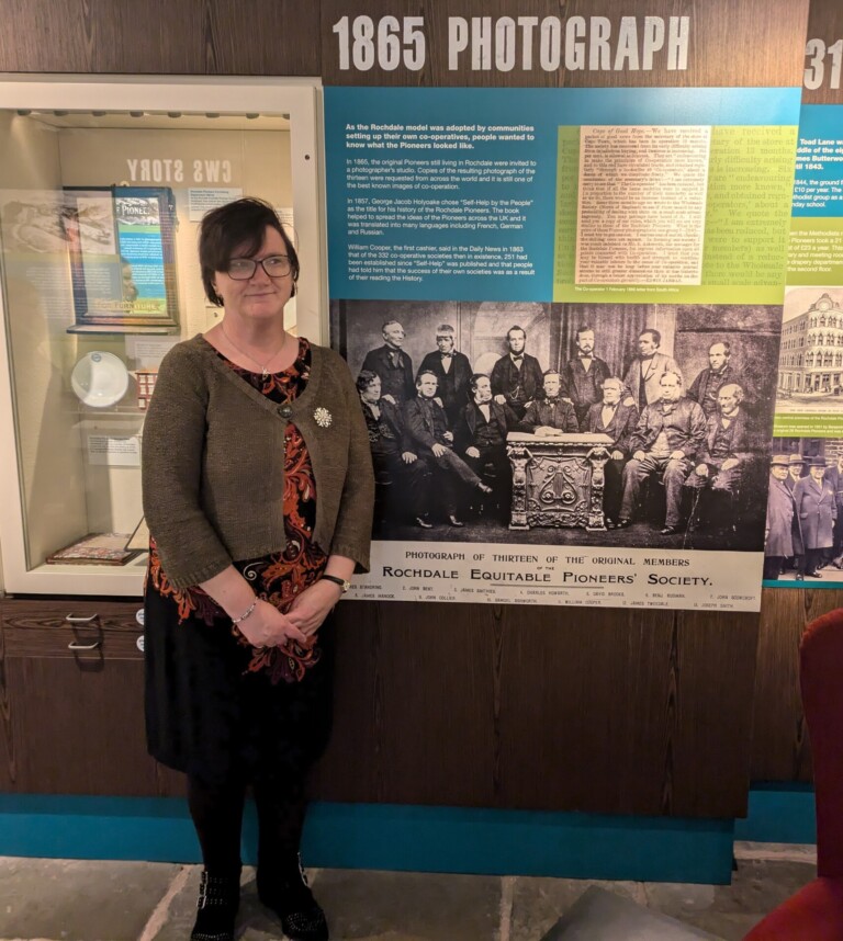 Louise Hewitt stod in front of an interpretation panel at the Rochdale Pioneers Museum