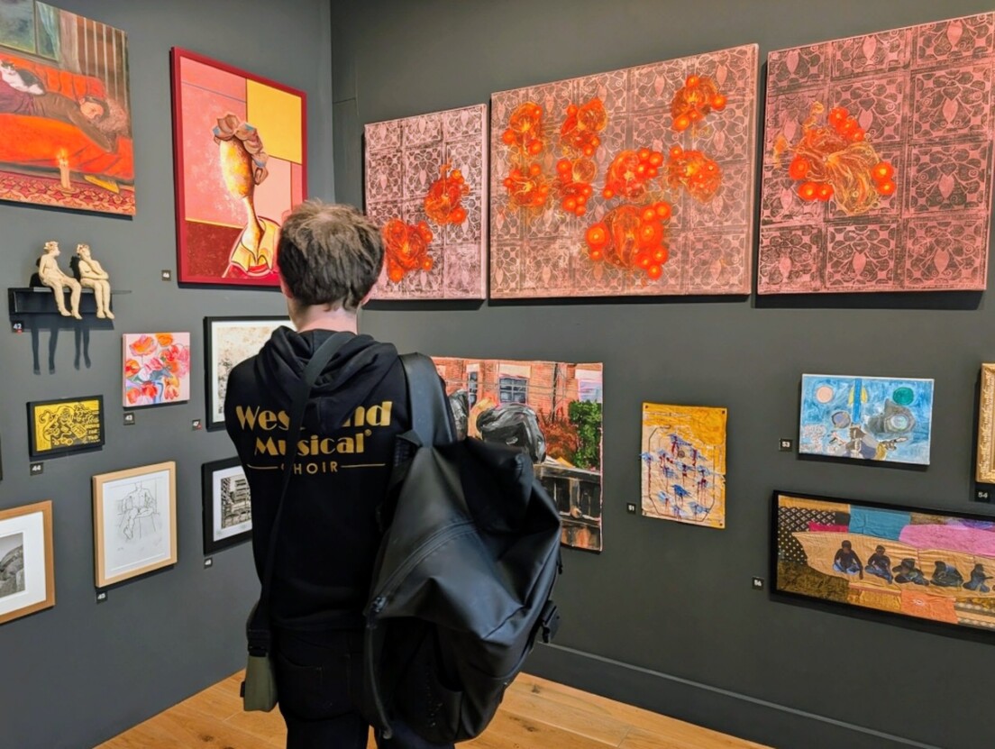 Venture Arts artist George Parker-Conway looking at the artwork on the gallery walls at the Manchester Open at HOME.