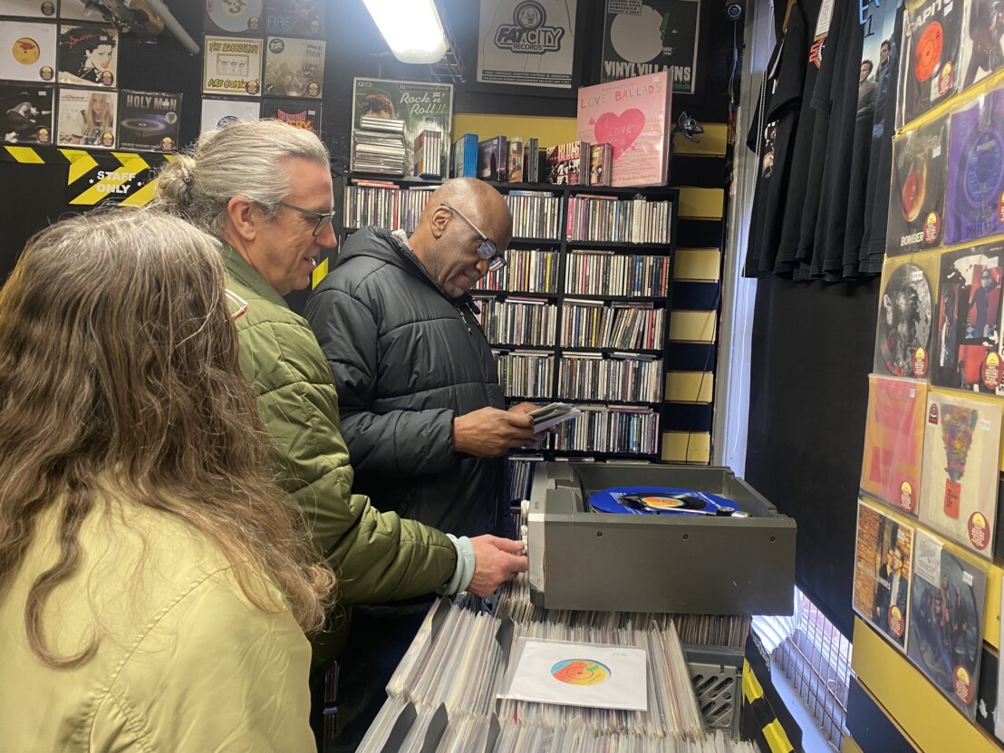 Venture Arts artist Horace in a record shop looking at records.