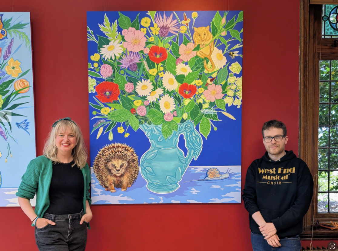 Venture Arts artist George Parker-Conway with artist and Venture Arts colleague Toni Miller standing in front of artwork in the Closer Still exhibition at The Old Parsonage.