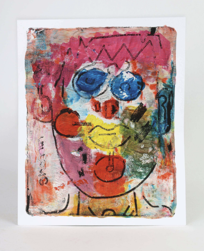 A gel print by Venture Arts studio artist Shannon Ratcliffe depicting an abstract face with blue eyes, a red nose, yellow mouth and pink hair.
